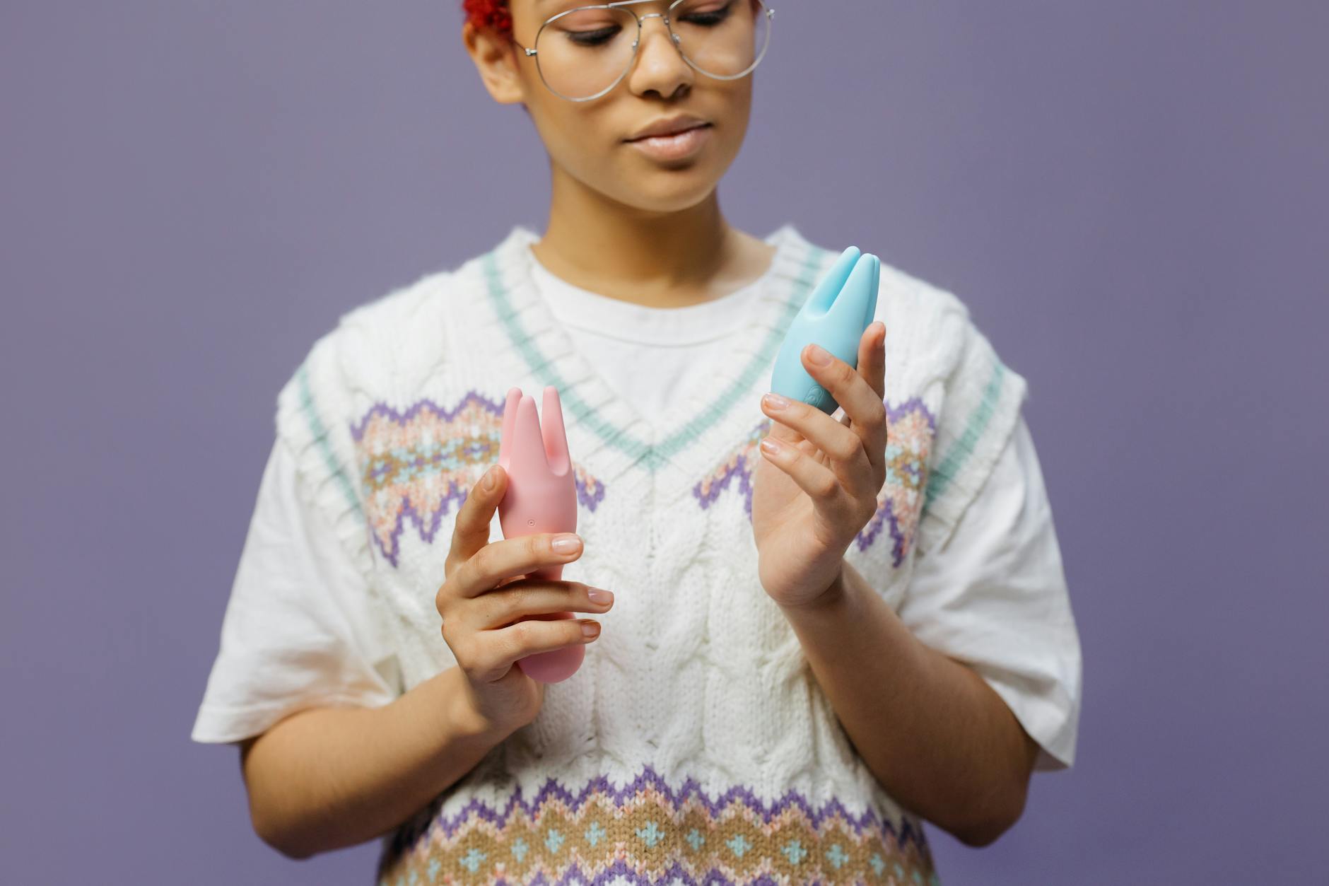 Hands holding colorful silicone vibrators in different skin tones, showing inclusivity in adult pleasure.